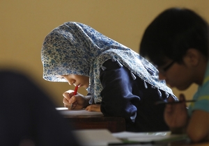 Students who have recently graduated from senior high school take part in a state university entrance exam in Jakarta