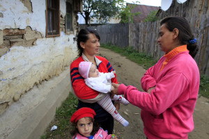 Roma women with children chat on a street in Prislop village, 300 km (184 miles) northwest of Bucharest where the majority of Roma people craft brooms and baskets made from twigs September 29, 2010. The European Commission will will not launch legal action against France on Wednesday over its expulsion of Roma migrants but give Paris more time to prove the policy is legal under EU law, EU diplomats said. France has sent around 8,000 Roma back to Romania and Bulgaria this year, bulldozing illegal camps where they were living on the outskirts of French cities. REUTERS/Radu Sigheti  (ROMANIA - Tags: POLITICS SOCIETY) - RTXSSV0