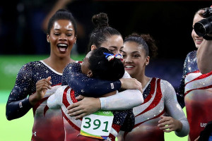 RIO DE JANEIRO, BRAZIL - AUGUST 09: Simone Biles (front) of the United States is congratulated by her team mates after competing on the floor during the Artistic Gymnastics Women's Team Final on Day 4 of the Rio 2016 Olympic Games at the Rio Olympic Arena on August 9, 2016 in Rio de Janeiro, Brazil. (Photo by Lars Baron/Getty Images)